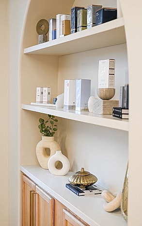 Stylish shelves with skincare products and decor.