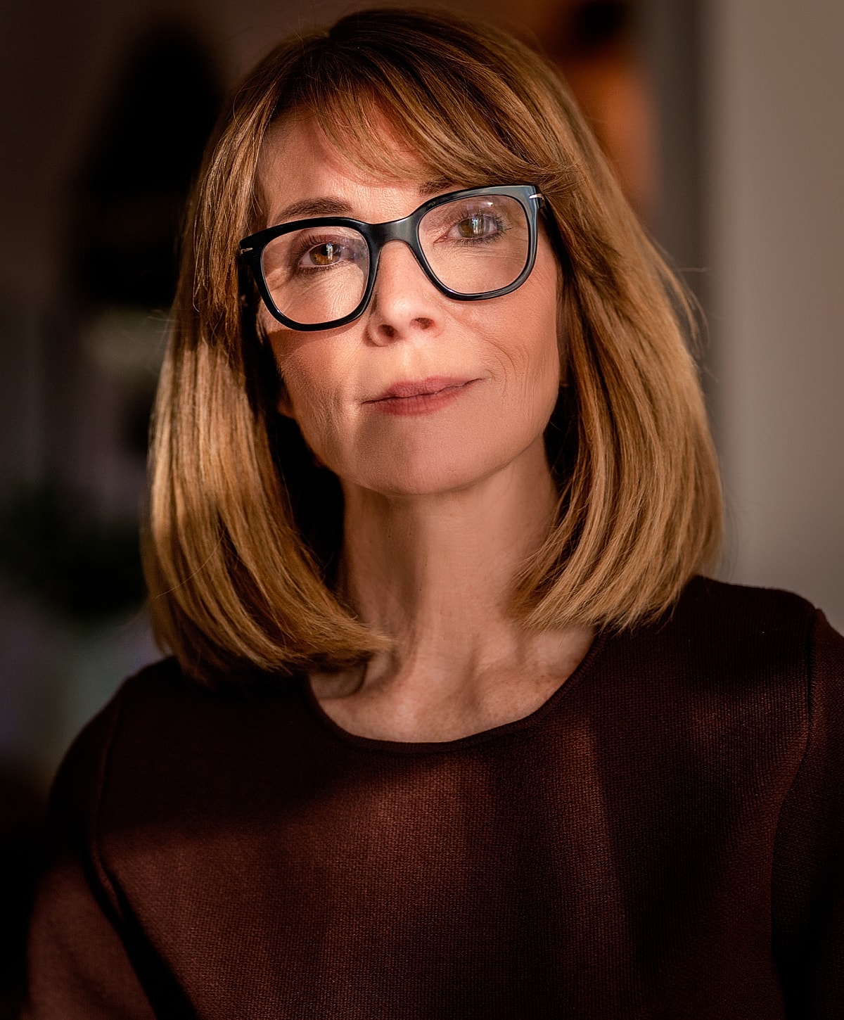 Portrait of a woman with glasses and soft lighting