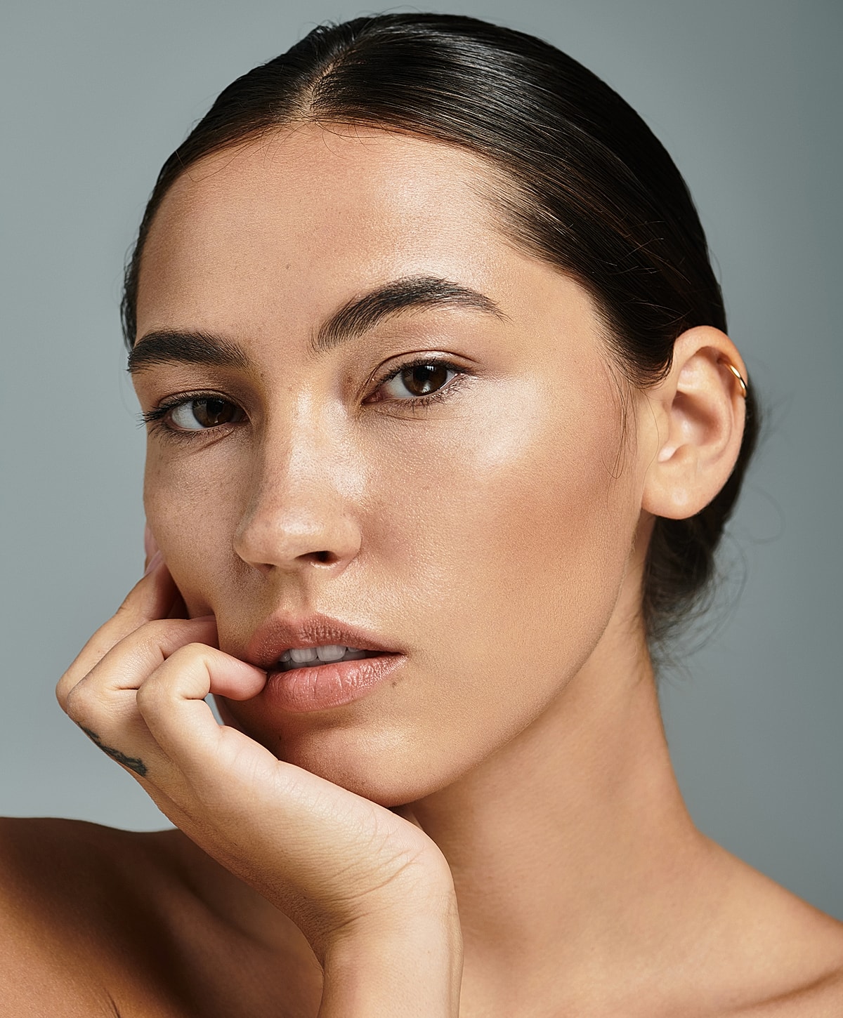 Close-up portrait of a woman with neutral expression.