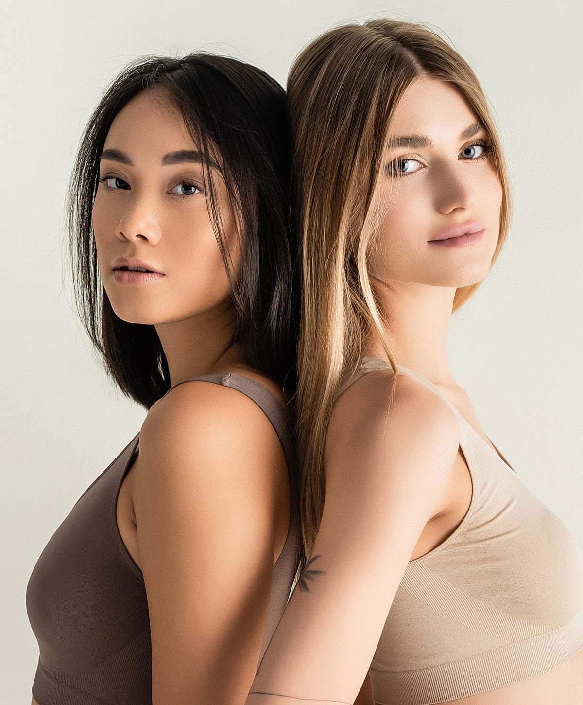 Diverse models posing back-to-back in casual tops.
