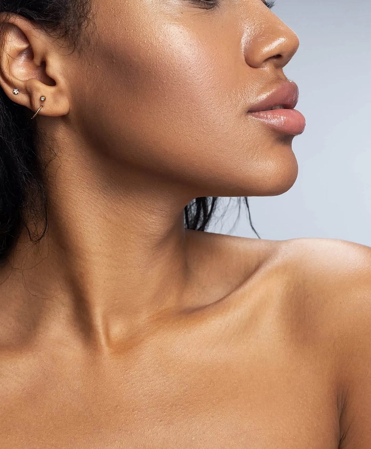 Close-up of woman's profile with jewelry.