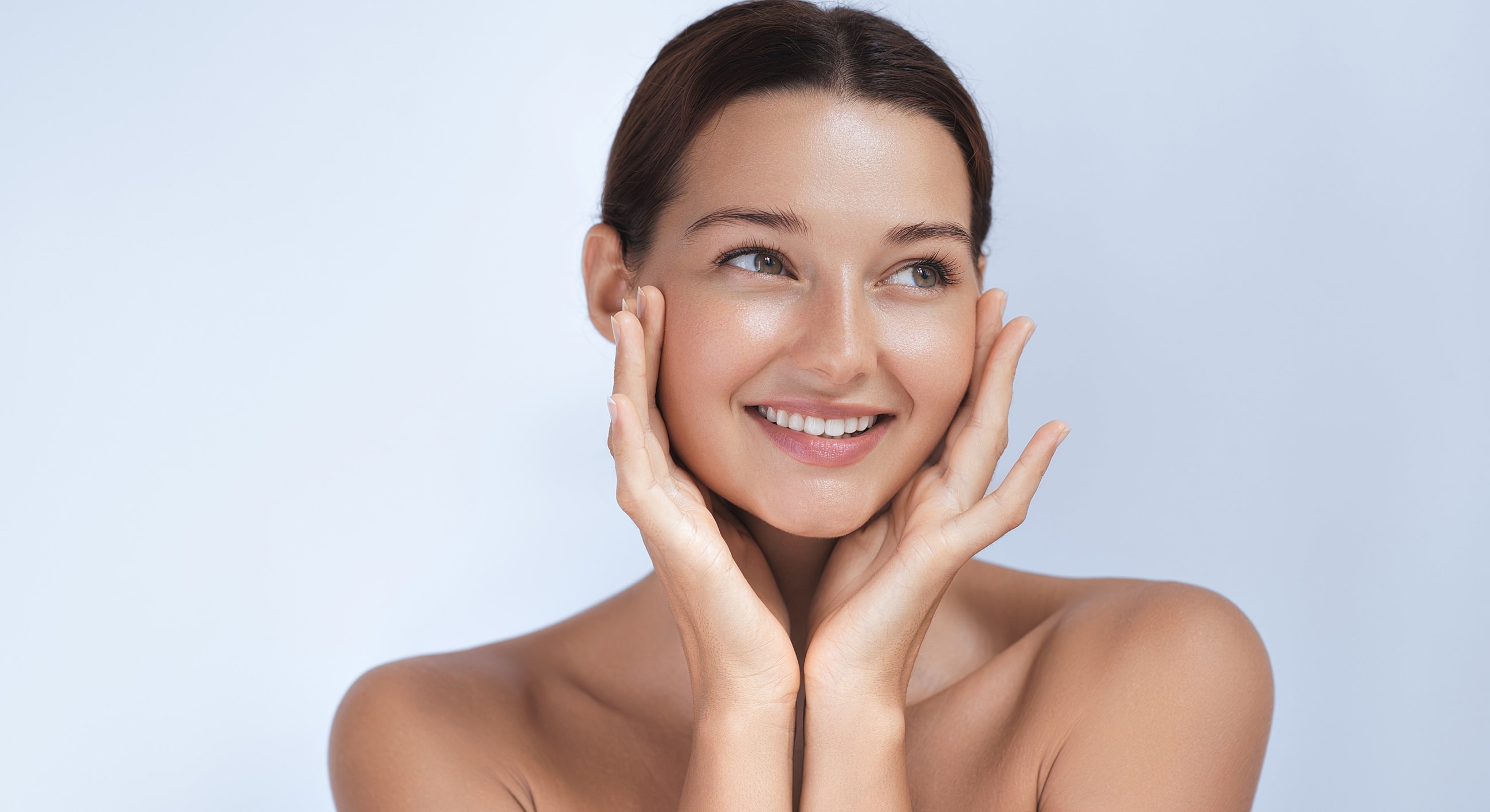 Smiling woman showcasing healthy, glowing skin.