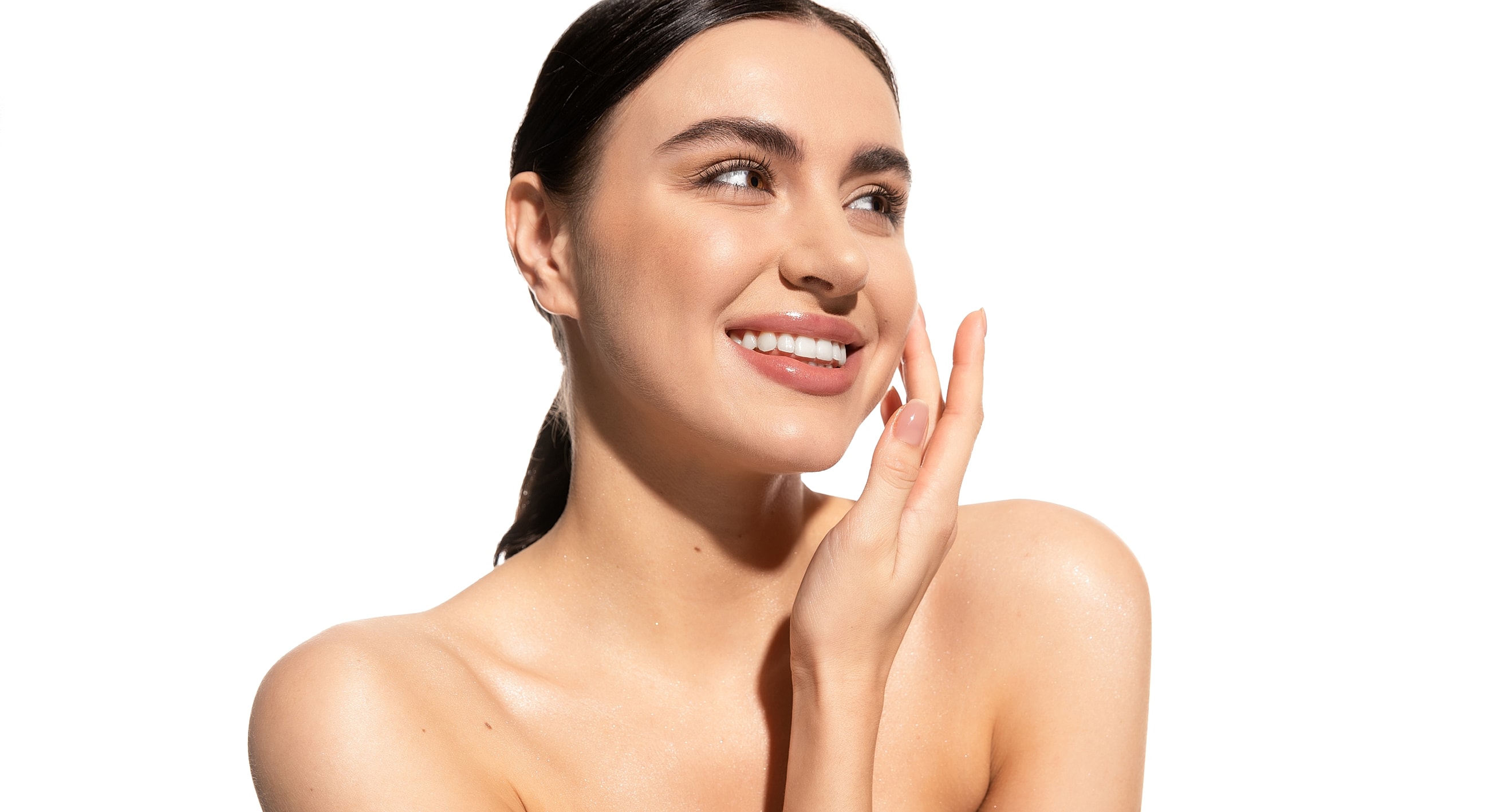 Smiling woman with glowing skin, light background